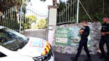 Police officers patrol in front of the Musee Renoir entrance after a theft.