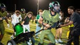Ryan Guzman carries the Bell across the field after Victor Valley beats Apple Valley.