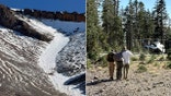 rescuers carry a hiker down a trail
