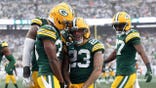 Skyy Moore and Marshawn Lloyd of the Green Bay Packers celebrate a field goal.