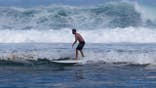 Surfer rides a wave at Saint-Gilles les bains beach in La Réunion.