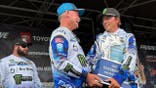Trey McKinney chats on stage while holding his 2026 Angler of the Year trophy.