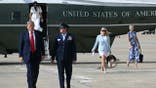 President Donald Trump, Karoline Leavitt and Natalie Harp walk toward Air Force One at Joint Base Andrews.