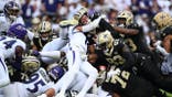 Tyler Shough runs with the ball during an NFL game in Baltimore.