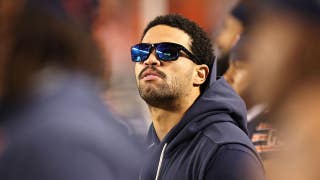 Caleb Williams, limited by a hamstring injury, seen casually pacing Bears sideline during national anthem