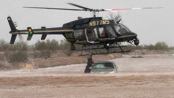 Helicopter swoops in to pull two people in their 80s from a flooded car - Fox News