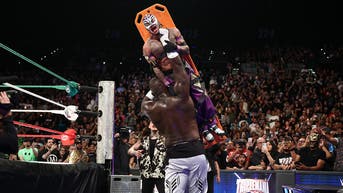 Omos slams strapped-in legend through the announcer table after the bell at Triplemania - Fox News
