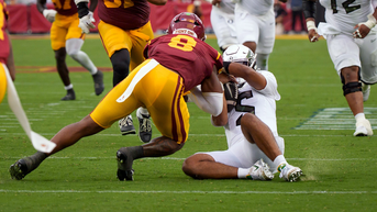 Ejected Trojan linebacker's shocking sideline behavior while rival QB gets carted off - Fox News