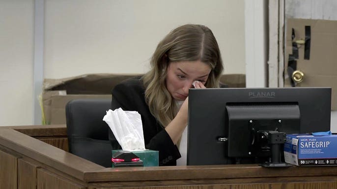 Alleigha Botner wipes tears from her eyes while testifying from the witness stand during Caleb Flynn’s murder trial in Ohio.
