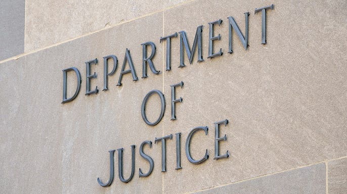 DOJ sign on the edifice of the building.