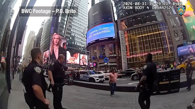 NYPD body camera image shows a woman holding two knives as officers confront her outside One Times Square in Manhattan.