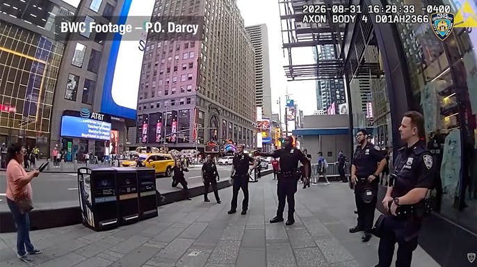 NYPD body camera image shows an officer speaking with a woman holding two knives during a Times Square standoff.