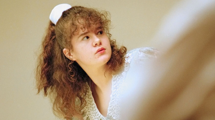 Christa Pike wearing white with curley red hair at trial in 1996