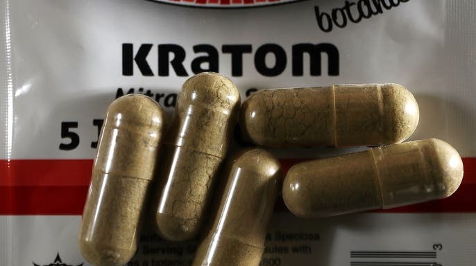 Kratom pills on a surface.