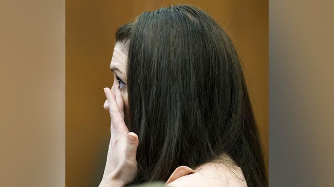 Lindsay Clancy wipes away tears while listening to testimony in court.