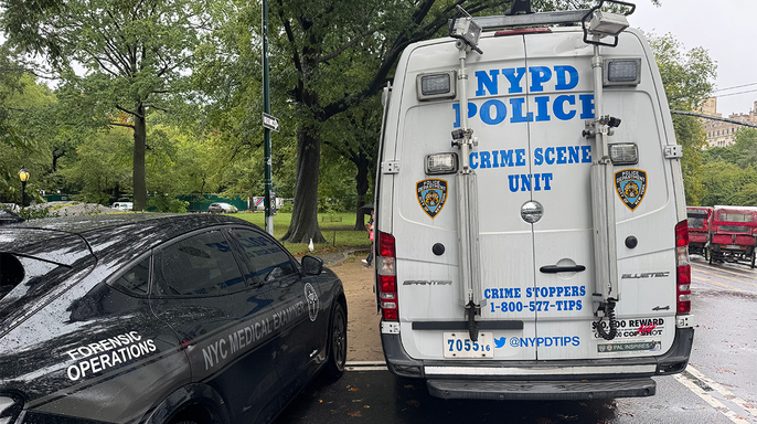 An NYPD Crime Scene Unit van and NYC medical examiner vehicle are parked near Central Park