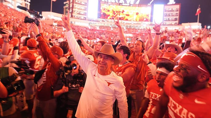 Steve Sarkisian celebrates with Texas players after a win over Ohio State.