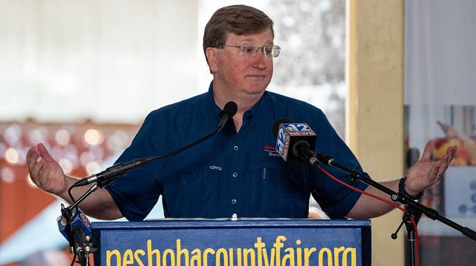 Gov. Tate Reeves gestures while speaking at the Neshoba County Fair in Philadelphia, Mississippi.