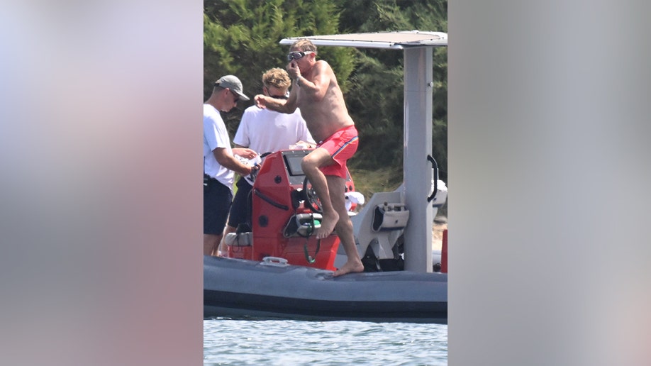 Simon Le Bon jumping off the boat and into the water while on vacation.