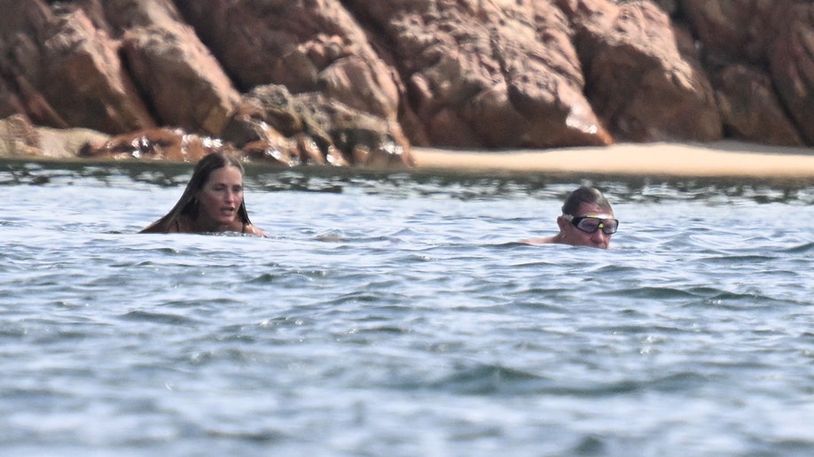 Yasmin Le Bon and Simon Le Bon swimming while in Italy.