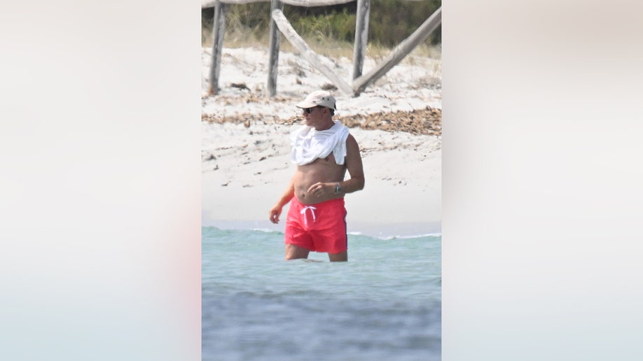 Simon Le Bon paired his red swimsuit with a white shirt, which he wore draped around his neck.