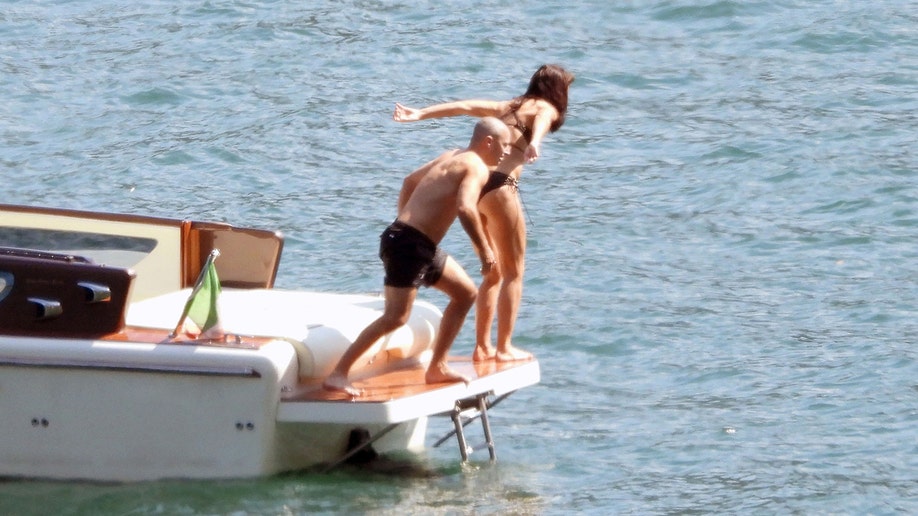 Katie Holmes and Jason Bard Yarmosky getting ready to jump in the pool.