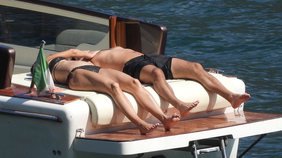 Katie Holmes and Jason Bard Yarmosky sunbathed on the back of a boat while in Italy.