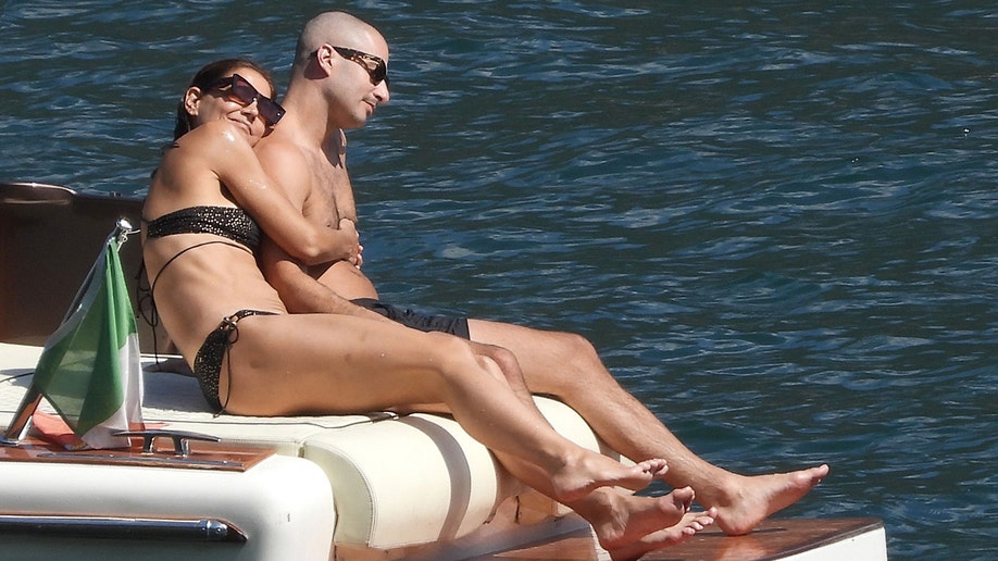 Katie Holmes snuggled with her boyfriend while on the back of the boat in Lake Como.