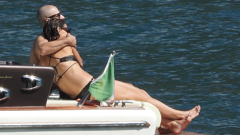 Jason Bard Yarmosky sat with his arm around Katie Holmes as they soaked up the sun while on vacation in Italy.