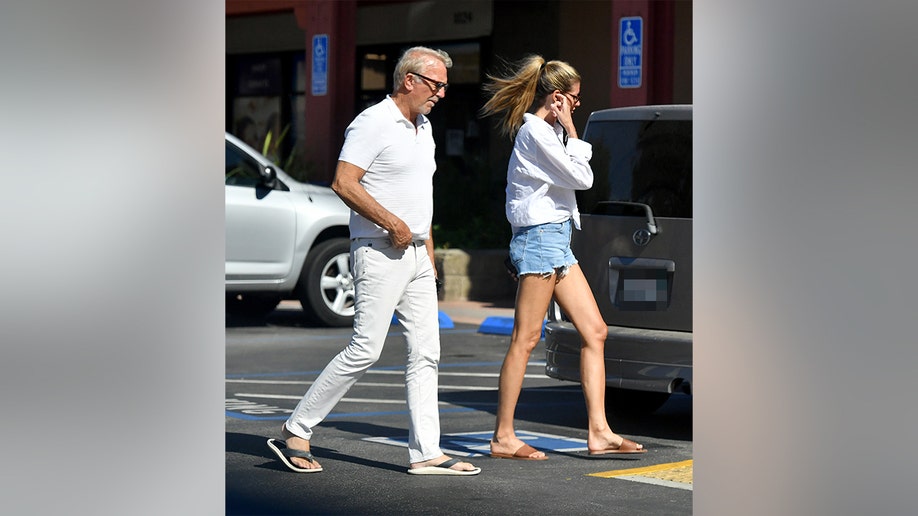 Costner and Milburn were side by side at they walked into the grocery store.