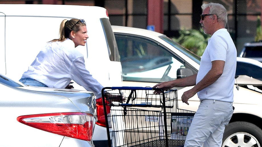 Kevin Costner and the lifestyle coach in the parking lot.