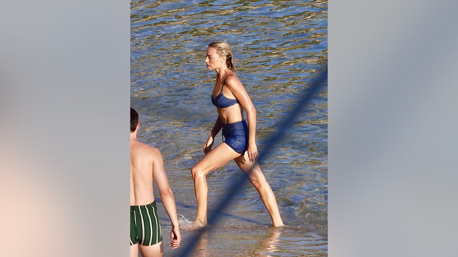 Margot Robbie getting out of the water
