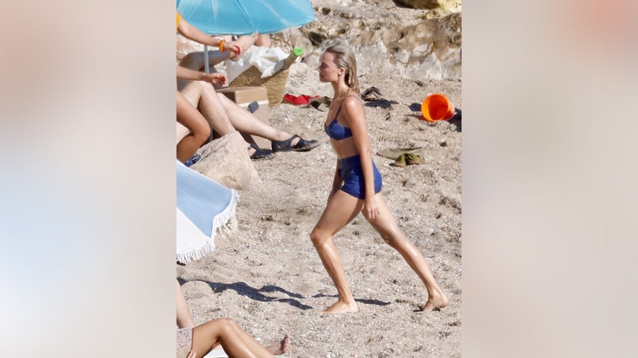 Margot Robbie walking on the sand in Saint-Tropez while filming.