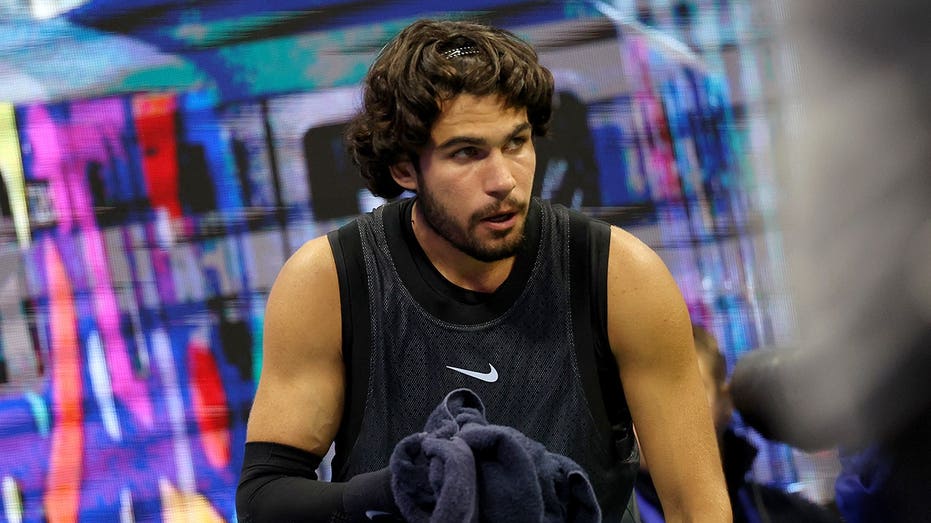 Tennis star Carlos Alcaraz vomits in towel during US Open thriller after trying to shoo cameras away