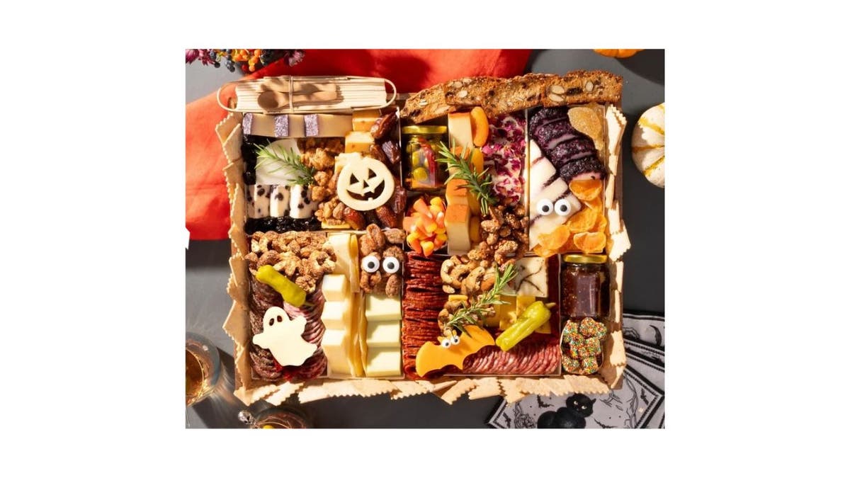 Halloween-themed charcuterie board on a gray table.