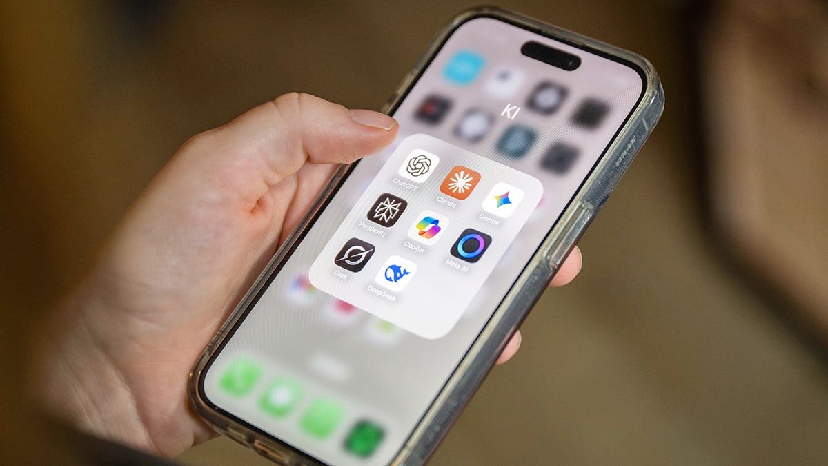Person holding a phone with AI apps.