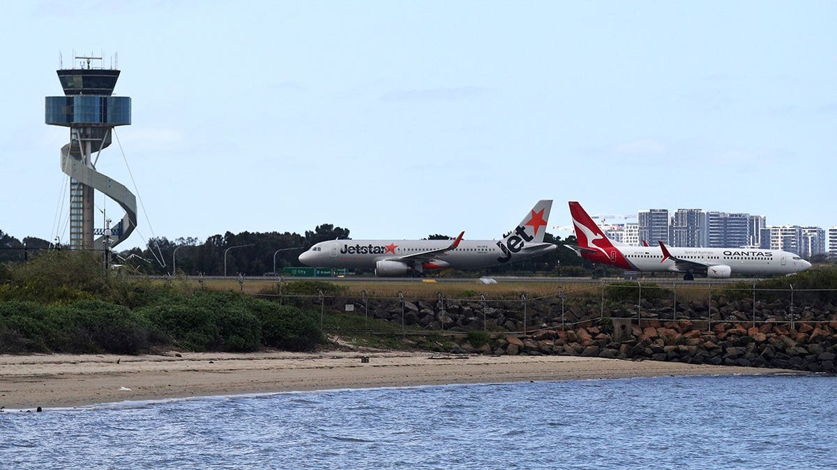 Two aircraft sitting on Sydney runway