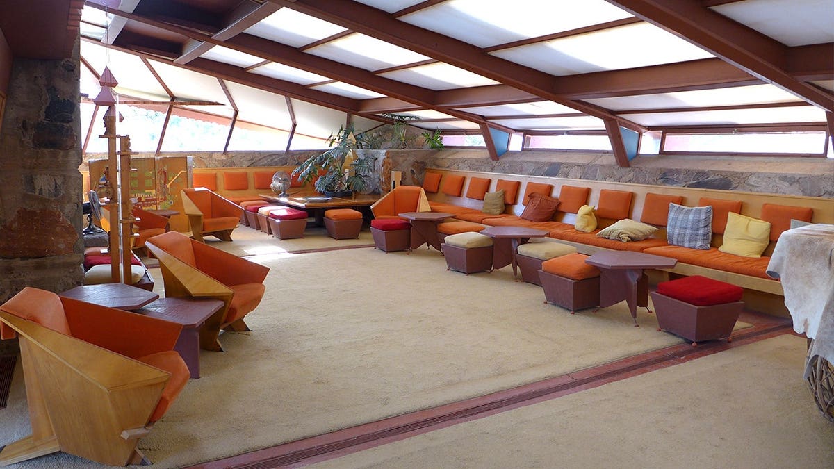 Interior of Taliesin with curved roofs, long couches