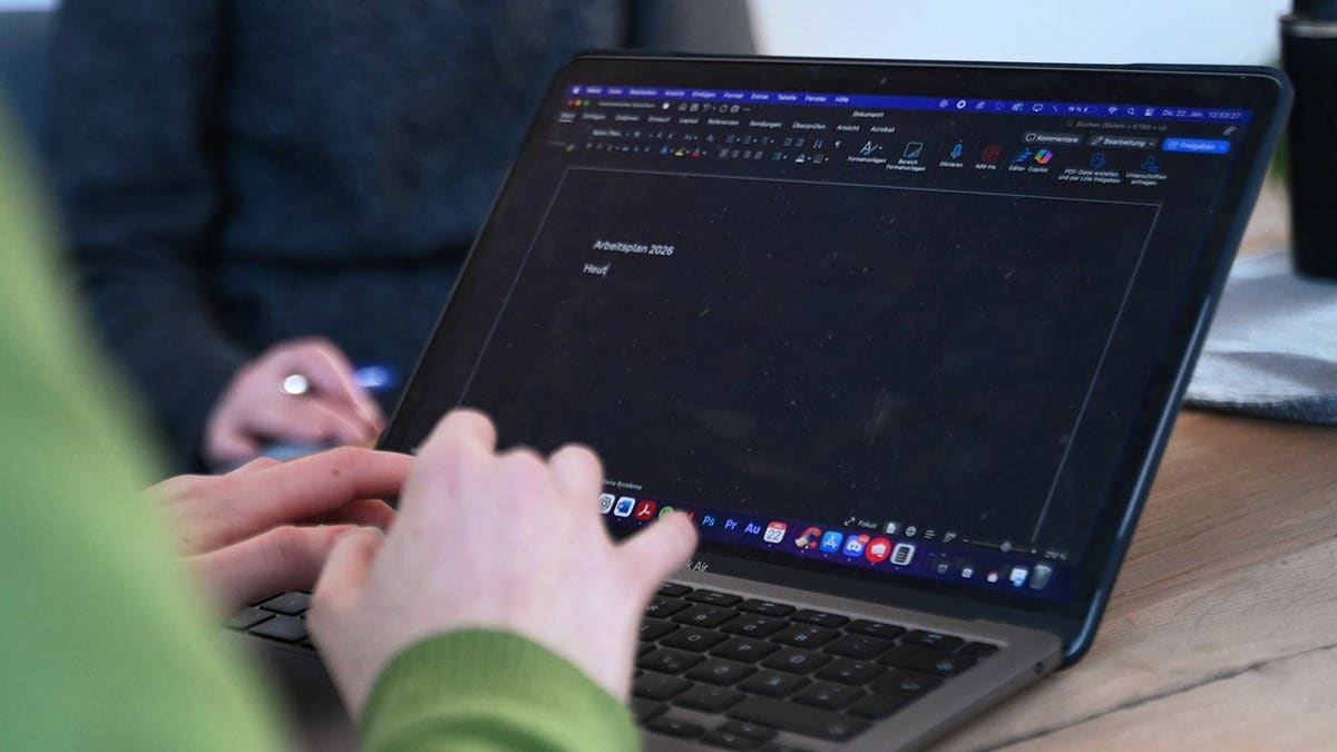 Person typing on their laptop.