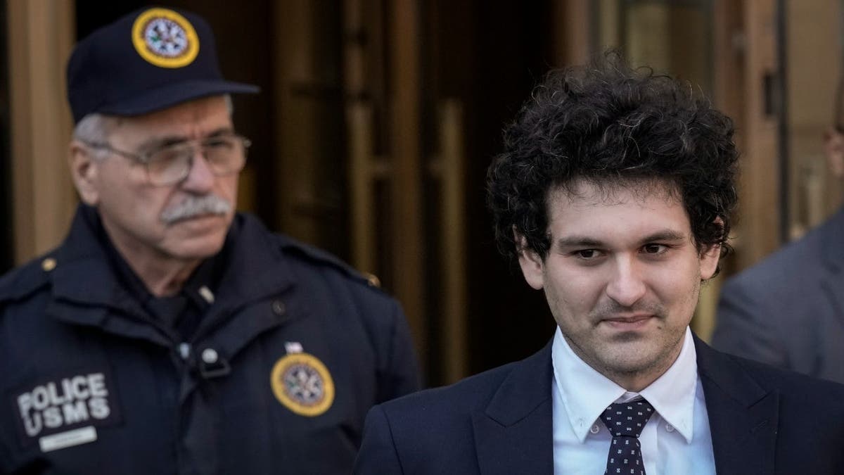 NEW YORK, NY - MARCH 30: FTX founder Sam Bankman-Fried (R) departs Manhattan Federal Court after an arraignment hearing on March 30, 2023 in New York City. Federal prosecutors added a foreign bribery charge to the list of crimes that Bankman-Fried is already facing. The indictment accuses the FTX founder of directing $40 million in bribes to Chinese government officials to unfreeze assets related to his cryptocurrency business.