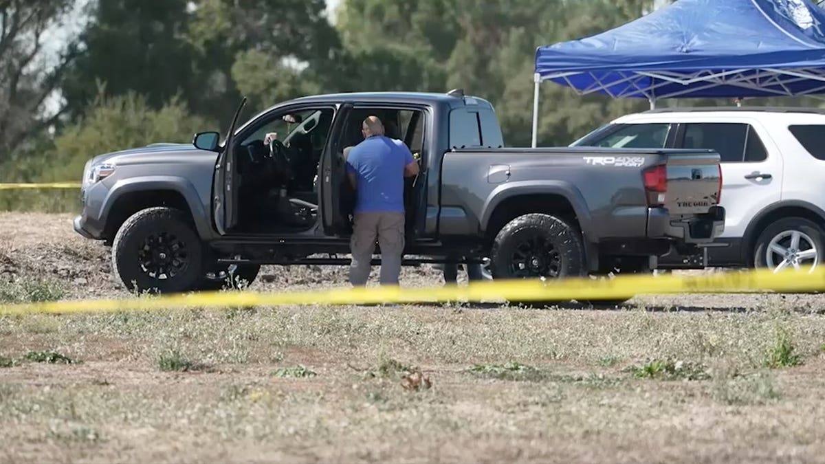 View of investigators on scene of plane crash