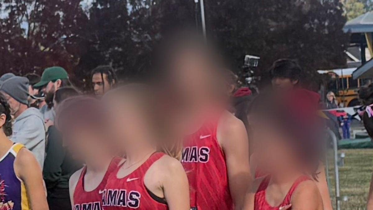 A Camas High cross country runner, who switched from the boys team to the girls team midseason, stands at the start line of a girls race in at the Nike Hole in the Wall XC Invitational.