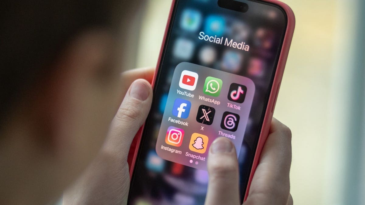 BATH, UNITED KINGDOM - FEBRUARY 25: In this photo illustration a a 12-year-old school boy looks at a iPhone screen A 12-year-old boy looks at an iPhone screen showing various social media apps including TikTok, Facebook and X on February 25, 2024 in Bath, England. This week the UK government issued new guidance backing headteachers in prohibiting the use of mobile phones throughout the school day, including at break times. Many schools around the country are already prohibiting mobile phone use over concerns. The amount of time children spend on screens each day rocketed during the Covid pandemic by more than 50 per cent, the equivalent of an extra hour and twenty minutes.