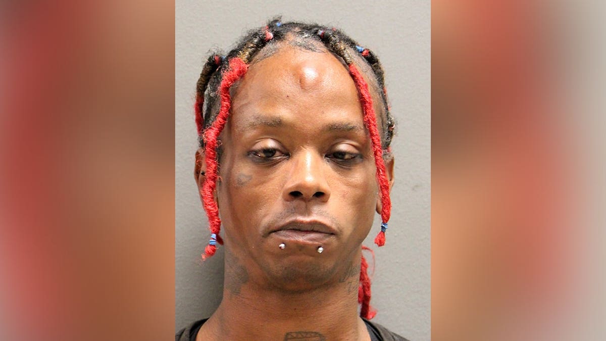 Chicago Police Department booking photo of Kelly Day, showing red-and-black braided hair, facial tattoos and two lower-lip piercings.
