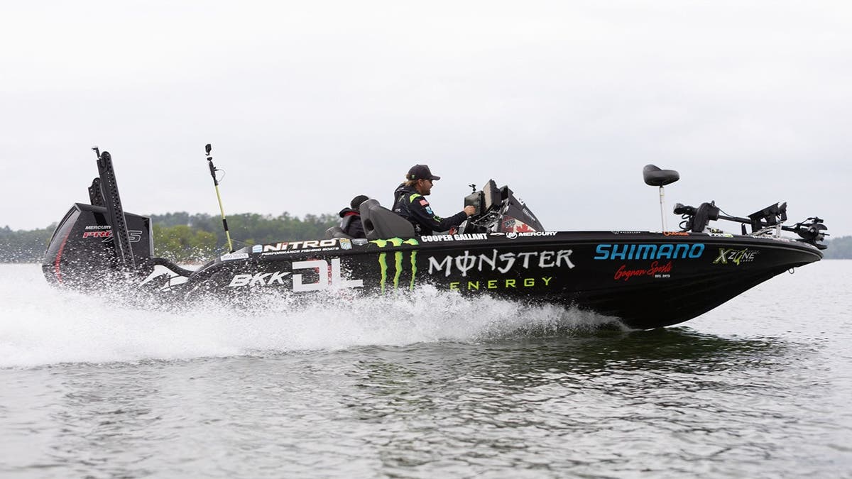 Cooper Gallant drives his bass boat across a lake