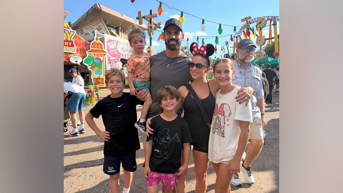 Jessie James Decker and Eric Decker pose with their four children at a Disney theme park during their Florida family vacation.