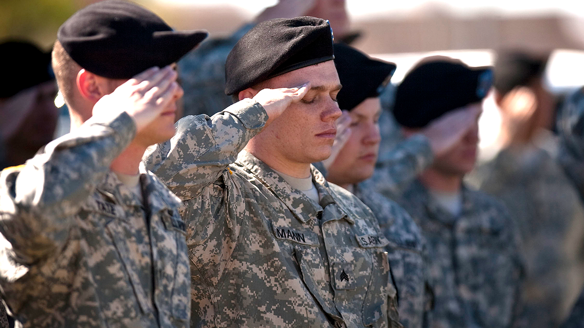 Soldiers salute during Fort Hood shooting anniversary remembrance ceremony.