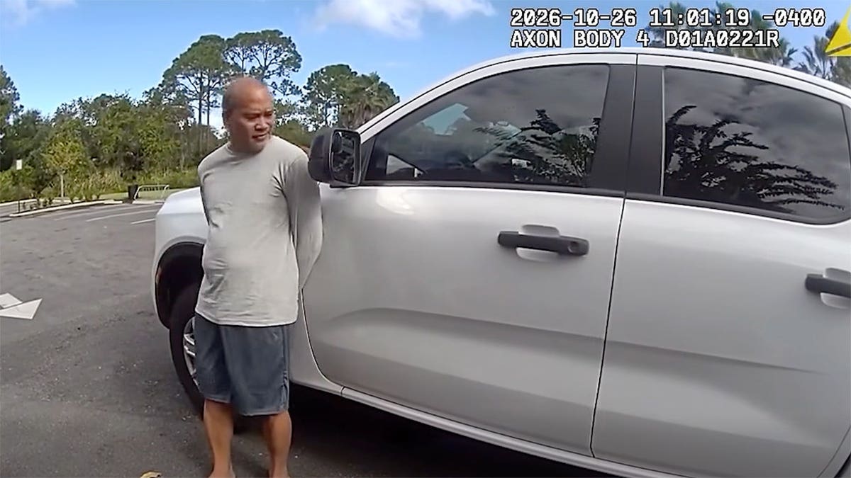 Epifanio IX Ramos Gaminde stands beside a white pickup truck in body-camera footage.