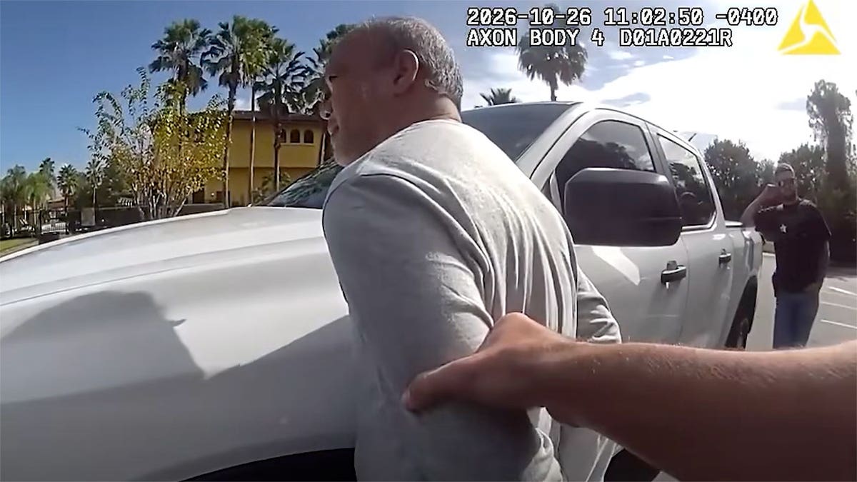 Body-camera footage shows Epifanio IX Ramos Gaminde being detained beside a white pickup truck.