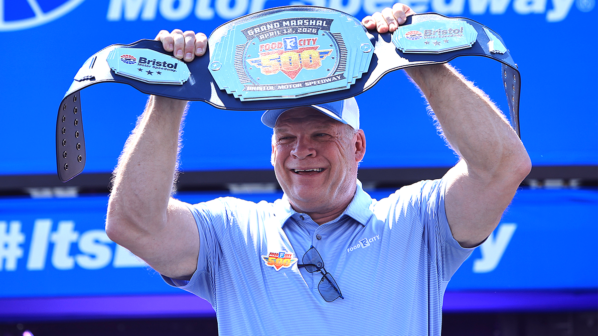 Knox County Mayor Glenn Jacobs walks onto pre-race stage at Bristol Motor Speedway.